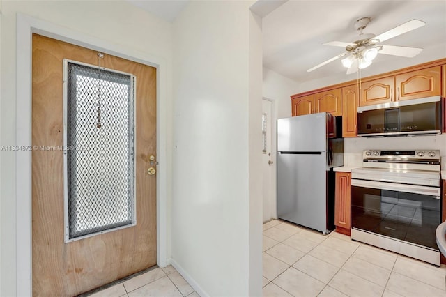 4341 NW 16th St Unit 203, Lauderhill, FL 33313 - kitchen with stainless steel appliances, ceiling fan, light tile patterned floors, and light countertops