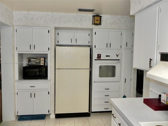 8225 SW 97th St, Miami, FL 33156 - kitchen featuring white appliances, light countertops, white cabinetry, and light tile patterned floors