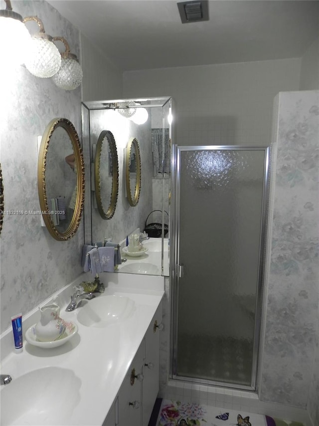 8225 SW 97th St, Miami, FL 33156 - bathroom with double vanity, wallpapered walls, and a stall shower