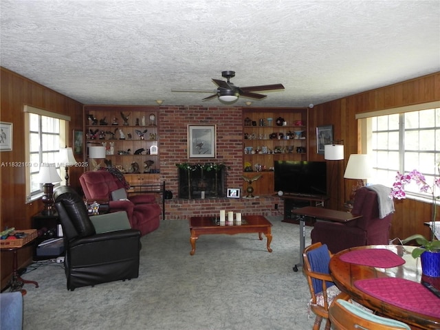 8225 SW 97th St, Miami, FL 33156 - living area featuring wooden walls, ceiling fan, carpet flooring, a textured ceiling, and a brick fireplace