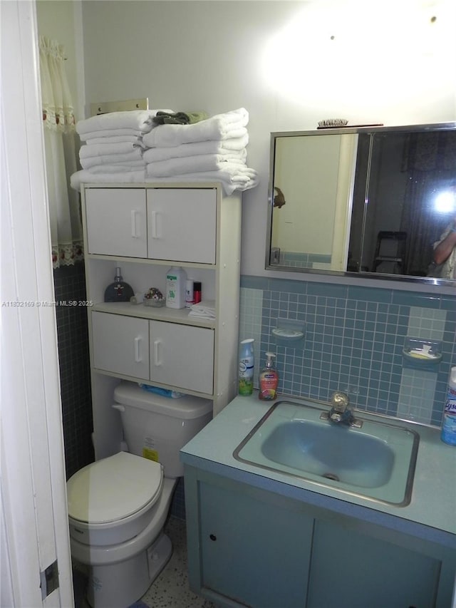 8225 SW 97th St, Miami, FL 33156 - bathroom featuring tile walls, vanity, and a wainscoted wall