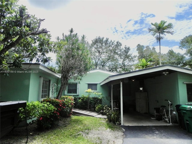 8225 SW 97th St, Miami, FL 33156 - rear view of property featuring stucco siding and a carport