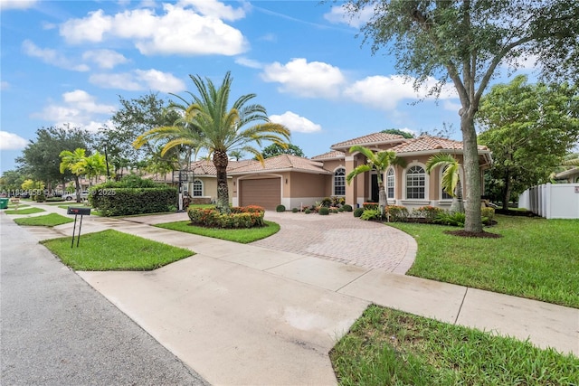 8346 SW 51st St, Davie, FL 33328 - mediterranean / spanish home featuring decorative driveway, an attached garage, stucco siding, and a tile roof