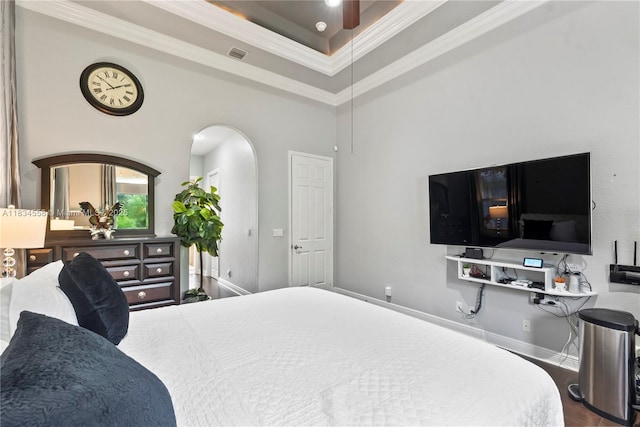 8346 SW 51st St, Davie, FL 33328 - bedroom with crown molding, a tray ceiling, wood finished floors, and arched walkways