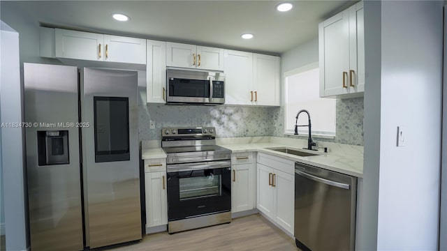 9601 Sunrise Lakes Blvd Unit 311, Sunrise, FL 33322 - kitchen with stainless steel appliances, white cabinets, light wood finished floors, recessed lighting, and backsplash