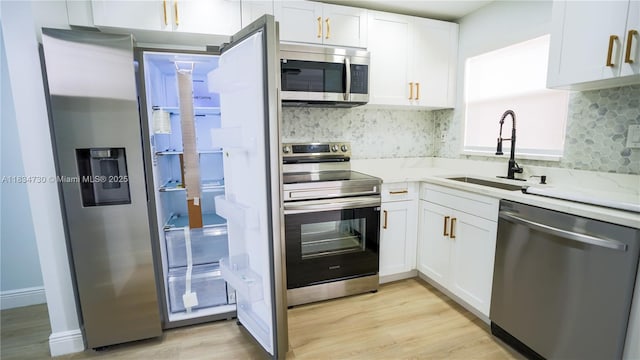 9601 Sunrise Lakes Blvd Unit 311, Sunrise, FL 33322 - kitchen featuring stainless steel appliances, light wood-style floors, white cabinetry, and backsplash