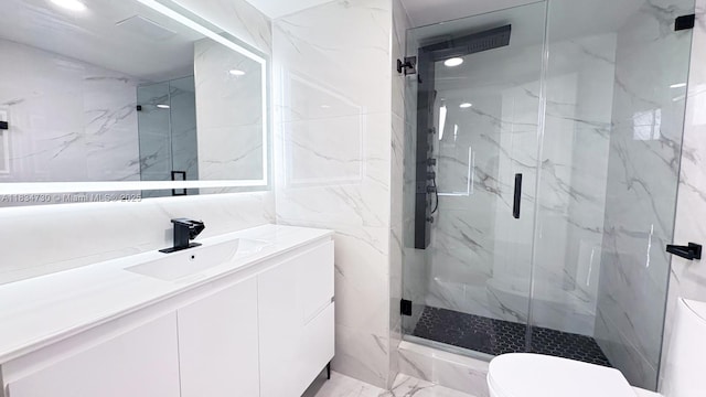 9601 Sunrise Lakes Blvd Unit 311, Sunrise, FL 33322 - bathroom with a marble finish shower, vanity, marble finish flooring, and tile walls