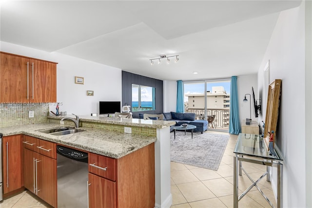 401 Ocean Dr Unit 1024, Miami Beach, FL 33139 - kitchen with dishwasher, a peninsula, open floor plan, light tile patterned floors, and decorative backsplash