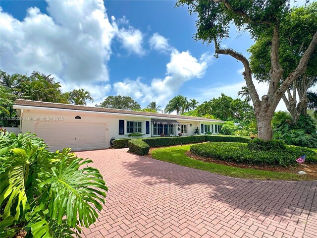 8225 SW 151st St, Palmetto Bay, FL 33158 - view of front of house featuring an attached garage, decorative driveway, and stucco siding