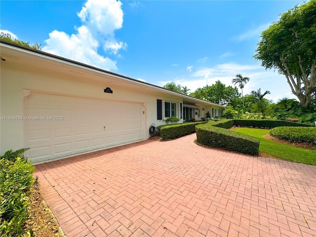 8225 SW 151st St, Palmetto Bay, FL 33158 - view of patio / terrace featuring decorative driveway and a garage