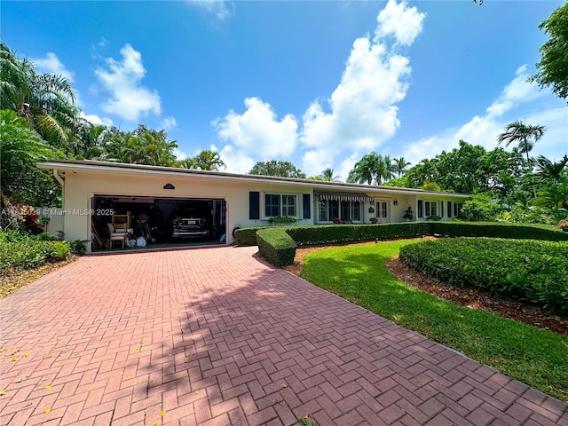 8225 SW 151st St, Palmetto Bay, FL 33158 - ranch-style home with a garage, decorative driveway, stucco siding, and a front lawn