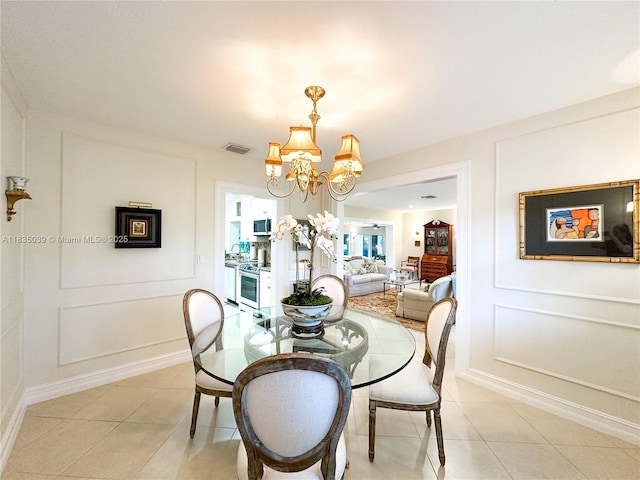8225 SW 151st St, Palmetto Bay, FL 33158 - dining space with a chandelier, light tile patterned floors, and a decorative wall