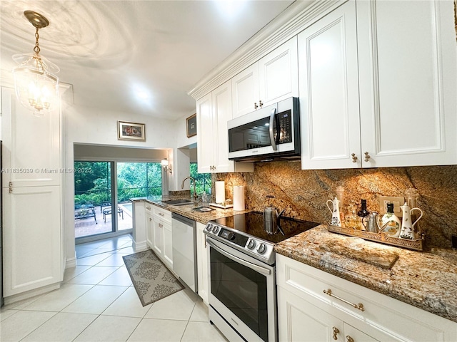 8225 SW 151st St, Palmetto Bay, FL 33158 - kitchen featuring stainless steel appliances, decorative backsplash, and white cabinetry