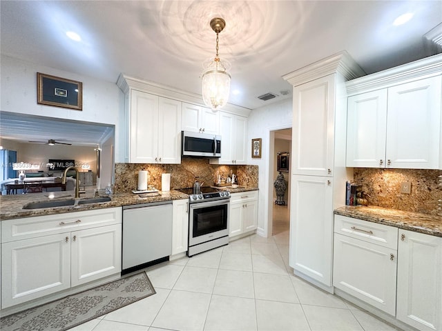 8225 SW 151st St, Palmetto Bay, FL 33158 - kitchen with dishwashing machine, stainless steel range with electric stovetop, backsplash, white cabinets, and dark stone counters