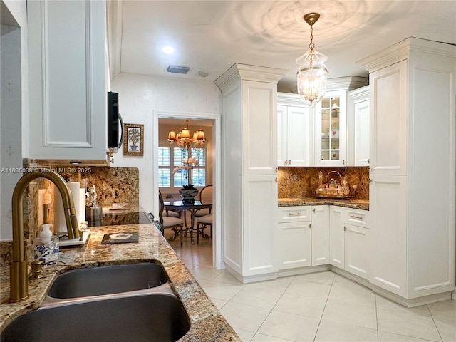 8225 SW 151st St, Palmetto Bay, FL 33158 - kitchen featuring a chandelier, light tile patterned flooring, tasteful backsplash, and stone countertops