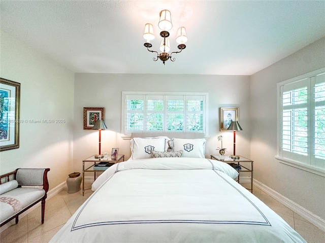 8225 SW 151st St, Palmetto Bay, FL 33158 - bedroom featuring light tile patterned flooring and a chandelier