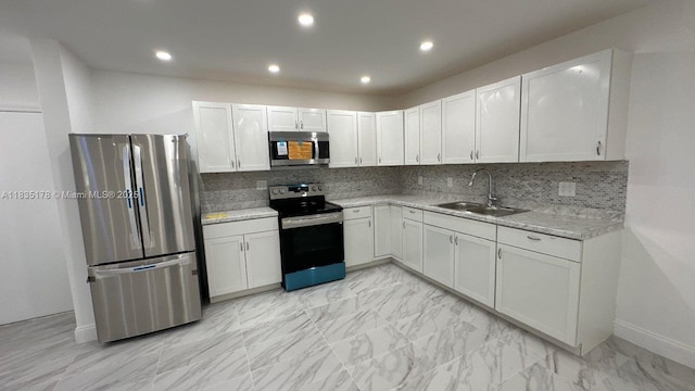 2251 NW 48th Ter Unit 214, Lauderhill, FL 33313 - kitchen featuring stainless steel appliances, tasteful backsplash, recessed lighting, white cabinets, and light marble finish floors
