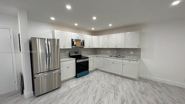 2251 NW 48th Ter Unit 214, Lauderhill, FL 33313 - kitchen featuring appliances with stainless steel finishes, backsplash, white cabinets, recessed lighting, and light stone countertops