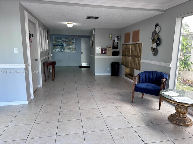 2251 NW 48th Ter Unit 214, Lauderhill, FL 33313 - sitting room featuring light tile patterned floors, healthy amount of natural light, and a textured ceiling