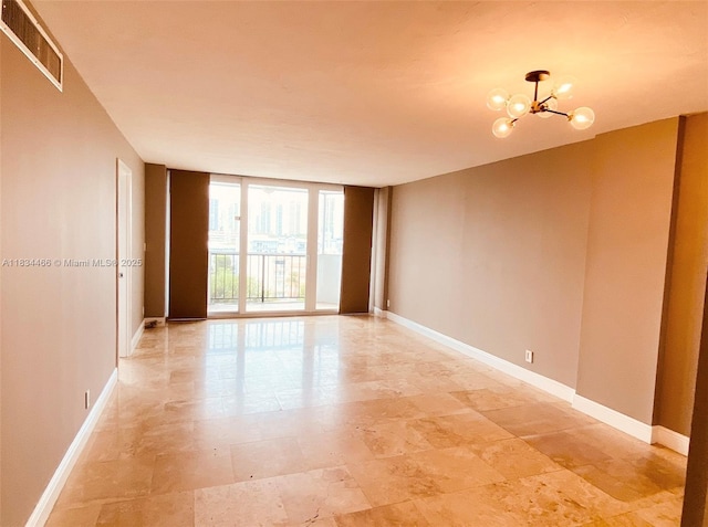 3545 NE 166th St Unit 805, North Miami Beach, FL 33160 - unfurnished room featuring a wall of windows and a chandelier
