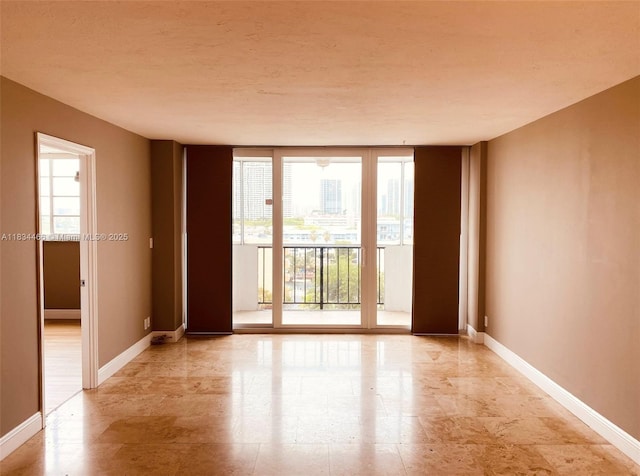 3545 NE 166th St Unit 805, North Miami Beach, FL 33160 - empty room featuring plenty of natural light and a wall of windows