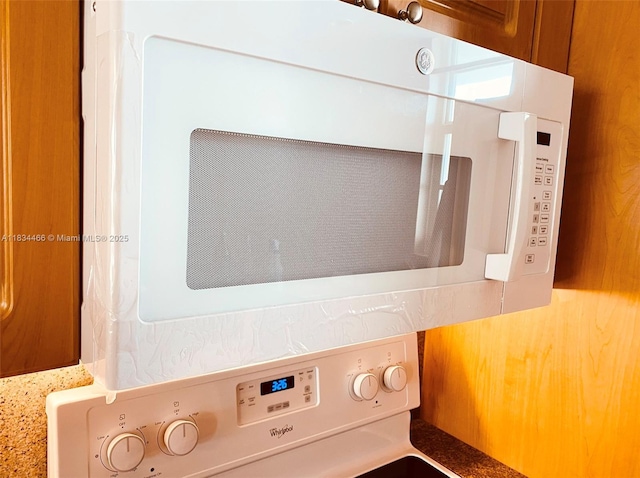 3545 NE 166th St Unit 805, North Miami Beach, FL 33160 - kitchen view of white microwave and stacked washer / dryer
