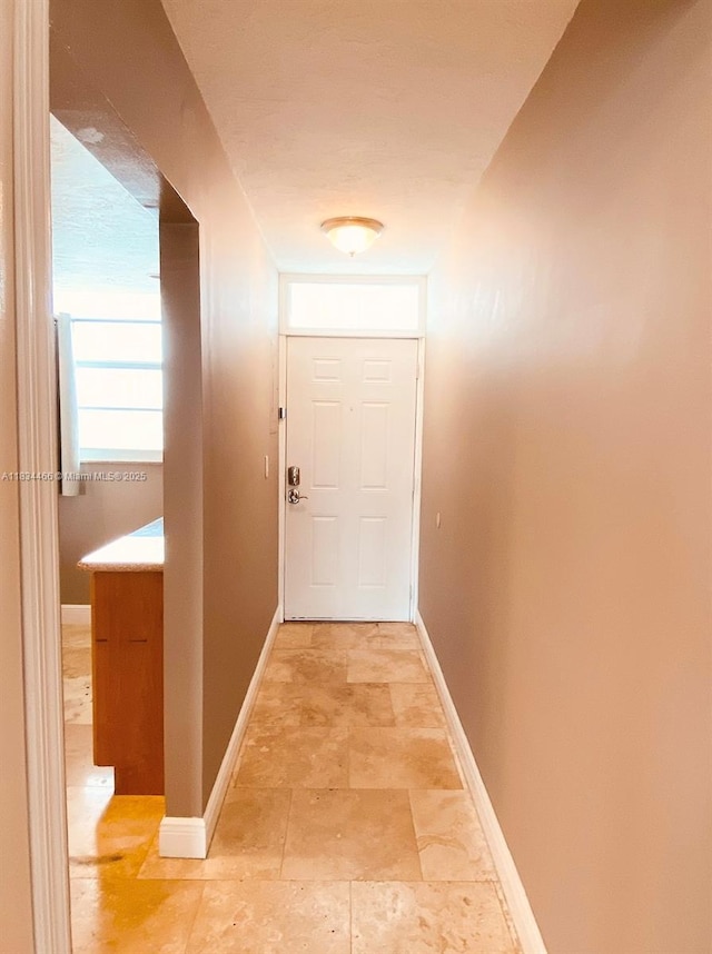 3545 NE 166th St Unit 805, North Miami Beach, FL 33160 - corridor with baseboards and light stone finish flooring