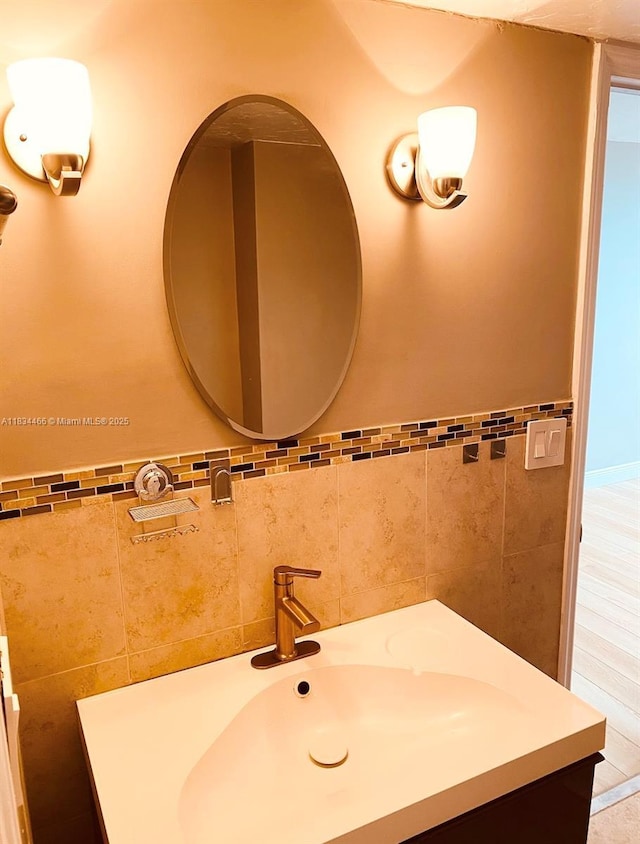 3545 NE 166th St Unit 805, North Miami Beach, FL 33160 - bathroom with vanity, tile walls, and a wainscoted wall