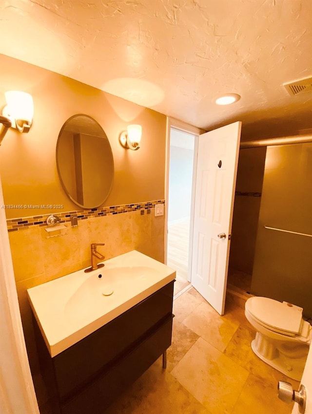 3545 NE 166th St Unit 805, North Miami Beach, FL 33160 - bathroom featuring tile walls, vanity, a stall shower, and recessed lighting
