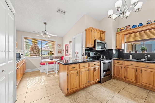 17130 SW 93rd Ave, Palmetto Bay, FL 33157 - kitchen with appliances with stainless steel finishes, tasteful backsplash, vaulted ceiling, a peninsula, and dark countertops