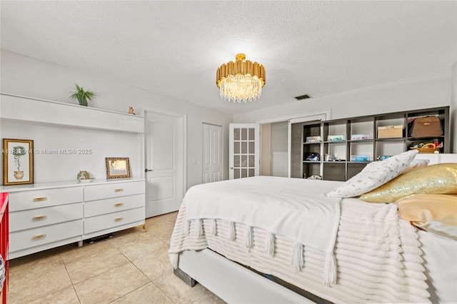 17130 SW 93rd Ave, Palmetto Bay, FL 33157 - bedroom with a chandelier, light tile patterned floors, and a textured ceiling