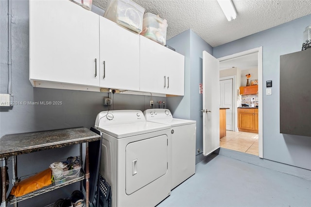 17130 SW 93rd Ave, Palmetto Bay, FL 33157 - laundry room with cabinet space, washing machine and dryer, and a textured ceiling