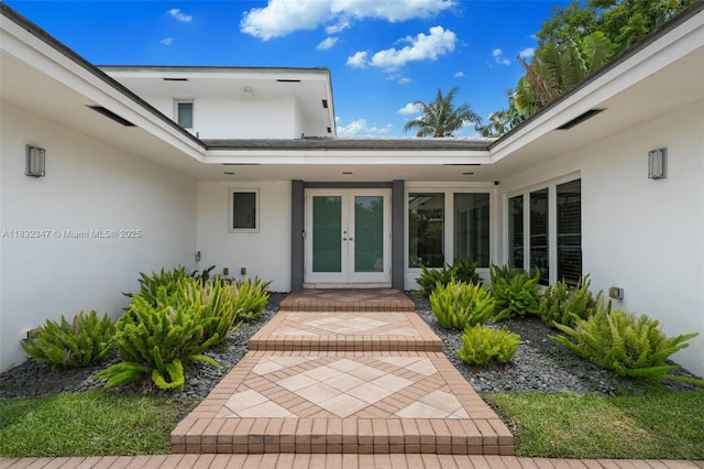 1231 96th St, Bay Harbor Islands, FL 33154 - view of exterior entry featuring stucco siding and french doors