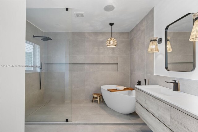 1231 96th St, Bay Harbor Islands, FL 33154 - full bathroom featuring a walk in shower, a freestanding tub, vanity, and tile walls