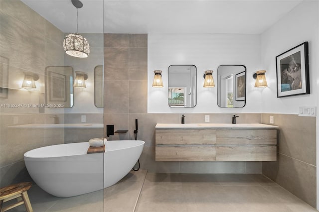 1231 96th St, Bay Harbor Islands, FL 33154 - full bath featuring tile walls, a freestanding tub, double vanity, and tile patterned flooring