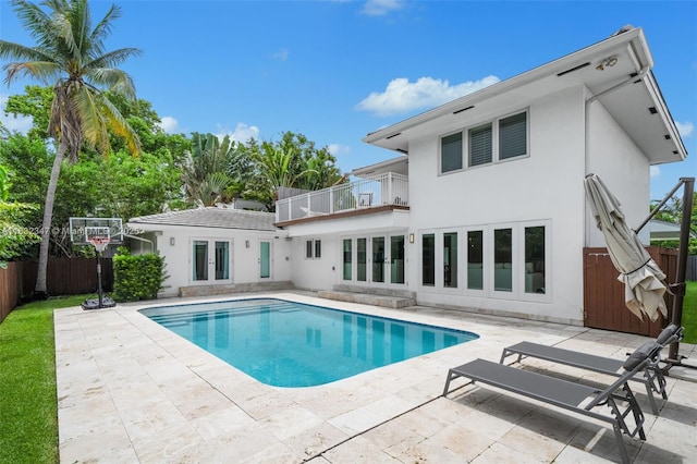 1231 96th St, Bay Harbor Islands, FL 33154 - rear view of property featuring a balcony, french doors, stucco siding, and a patio area