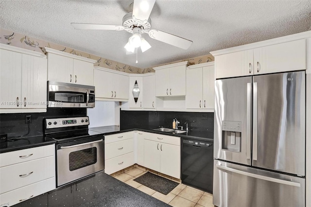 4965 E Sabal Palm Blvd Unit 207, Tamarac, FL 33319 - kitchen with appliances with stainless steel finishes, dark countertops, ceiling fan, white cabinets, and light tile patterned floors