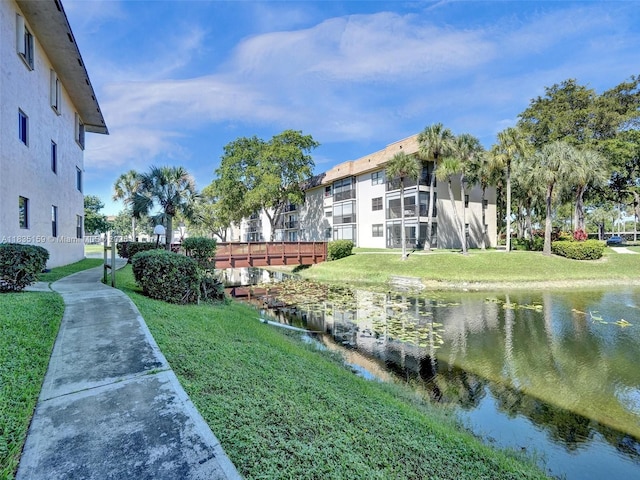 4965 E Sabal Palm Blvd Unit 207, Tamarac, FL 33319 - surrounding community with a water view and a lawn