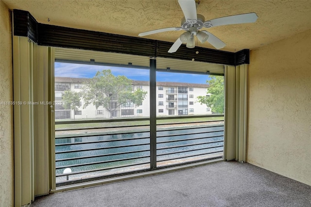 4965 E Sabal Palm Blvd Unit 207, Tamarac, FL 33319 - exterior space with a textured wall, a ceiling fan, and a textured ceiling