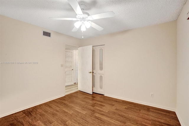 4965 E Sabal Palm Blvd Unit 207, Tamarac, FL 33319 - spare room featuring wood finished floors, a ceiling fan, and a textured ceiling