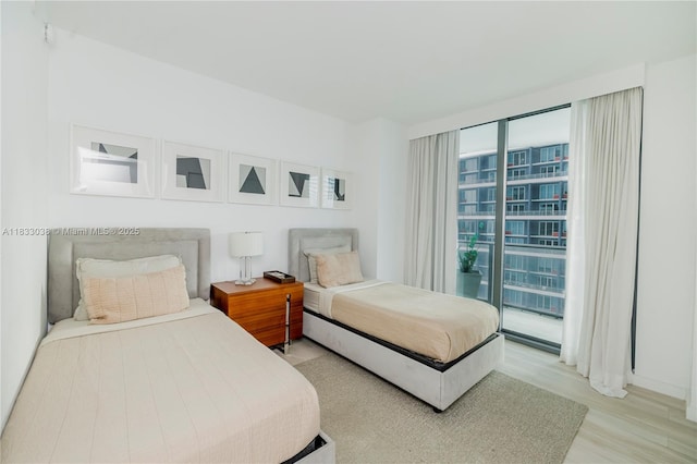 1300 S Miami Ave Unit 2210, Miami, FL 33130 - bedroom with light wood-type flooring and access to exterior