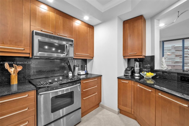 333 Las Olas Way Unit 405, Fort Lauderdale, FL 33301 - kitchen with stainless steel appliances, decorative backsplash, dark stone countertops, brown cabinetry, and recessed lighting