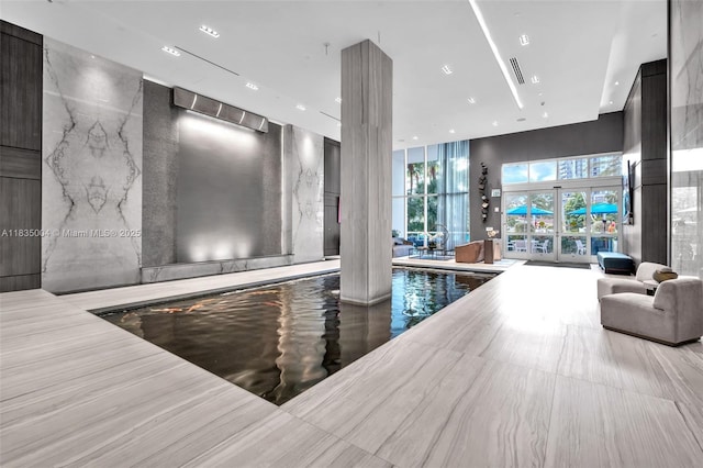 333 Las Olas Way Unit 405, Fort Lauderdale, FL 33301 - lobby with a wall of windows, recessed lighting, and a towering ceiling