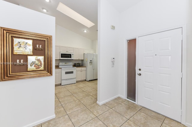 5570 Royal Lake Cir, Boynton Beach, FL 33437 - foyer entrance with a skylight, light tile patterned floors, and high vaulted ceiling