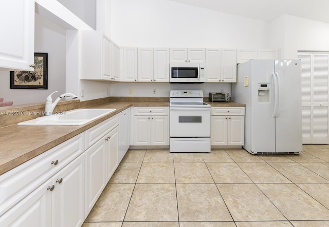 5570 Royal Lake Cir, Boynton Beach, FL 33437 - kitchen featuring white appliances, white cabinets, light tile patterned flooring, and high vaulted ceiling