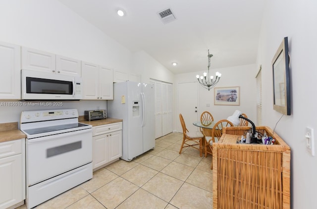 5570 Royal Lake Cir, Boynton Beach, FL 33437 - kitchen with white appliances, a chandelier, white cabinetry, light tile patterned flooring, and light countertops