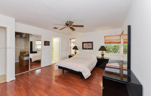 5570 Royal Lake Cir, Boynton Beach, FL 33437 - bedroom with wood finished floors, a textured ceiling, a ceiling fan, and a closet