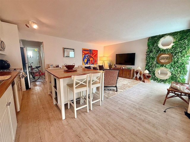 224 Meridian Ave Unit 10, Miami Beach, FL 33139 - kitchen with light wood-style floors, wooden counters, and white cabinets