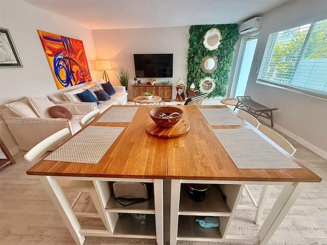 224 Meridian Ave Unit 10, Miami Beach, FL 33139 - dining area with a wall mounted AC and baseboards