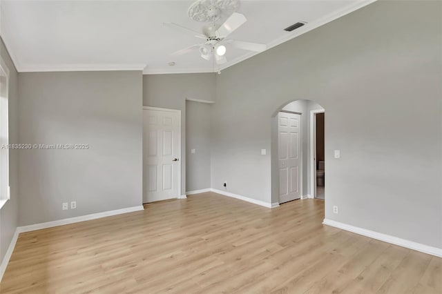 8018 Aberdeen Dr Unit 202, Boynton Beach, FL 33472 - spare room featuring arched walkways, ceiling fan, ornamental molding, and light wood-style flooring
